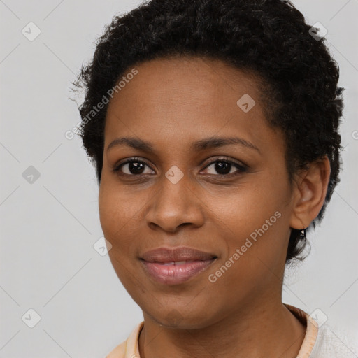 Joyful black young-adult female with short  brown hair and brown eyes