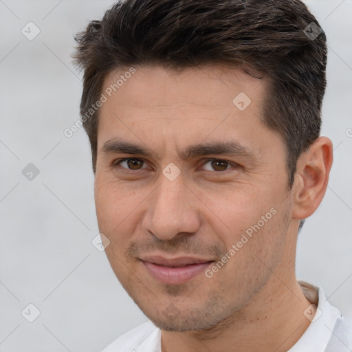 Joyful white adult male with short  brown hair and brown eyes