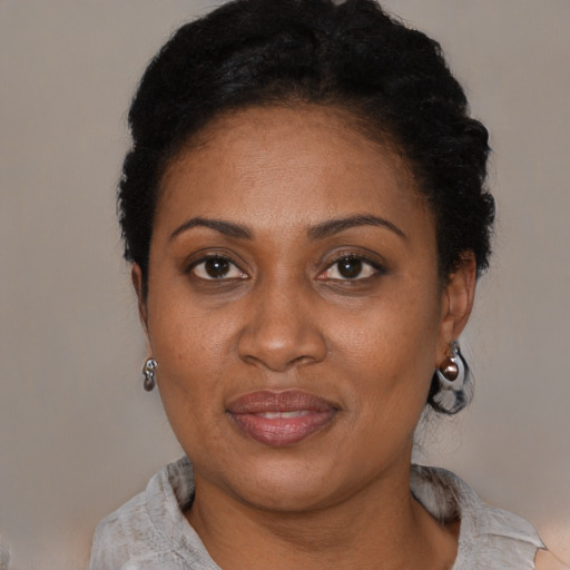 Joyful black adult female with short  black hair and brown eyes