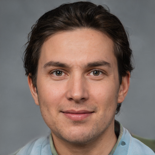 Joyful white adult male with short  brown hair and brown eyes