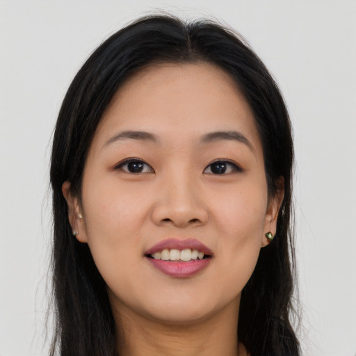 Joyful asian young-adult female with long  black hair and brown eyes