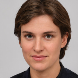 Joyful white young-adult female with medium  brown hair and grey eyes