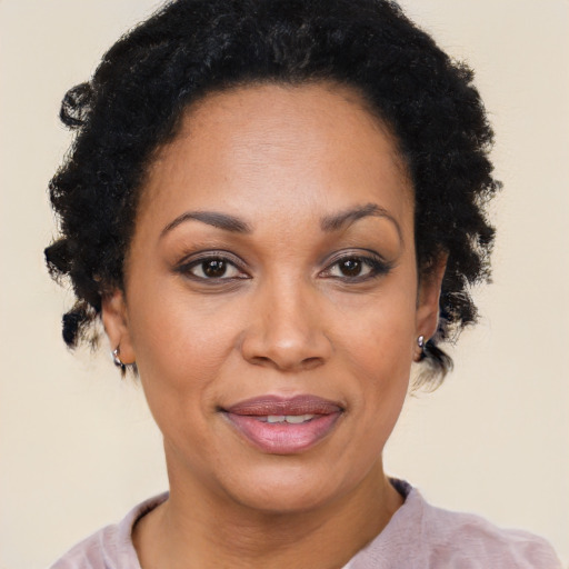 Joyful black adult female with short  brown hair and brown eyes