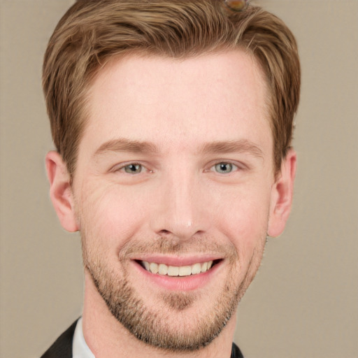 Joyful white young-adult male with short  brown hair and grey eyes