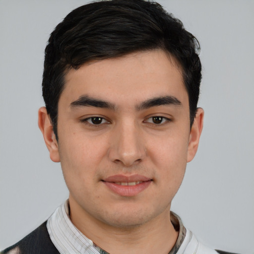 Joyful white young-adult male with short  black hair and brown eyes