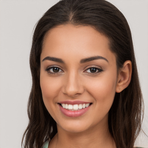 Joyful white young-adult female with long  brown hair and brown eyes