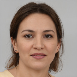 Joyful white young-adult female with medium  brown hair and brown eyes