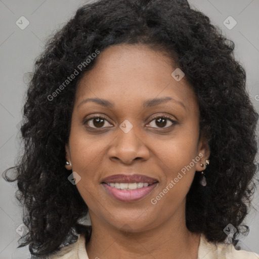 Joyful black young-adult female with long  brown hair and brown eyes