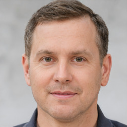 Joyful white adult male with short  brown hair and brown eyes