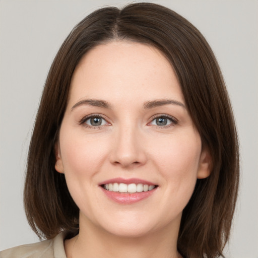 Joyful white young-adult female with medium  brown hair and brown eyes