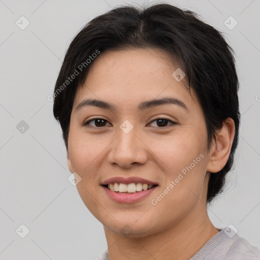 Joyful asian young-adult female with short  brown hair and brown eyes