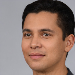 Joyful white young-adult male with short  black hair and brown eyes