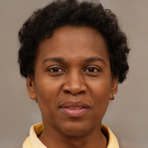 Joyful black adult female with short  brown hair and brown eyes