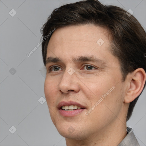 Joyful white adult male with short  brown hair and brown eyes