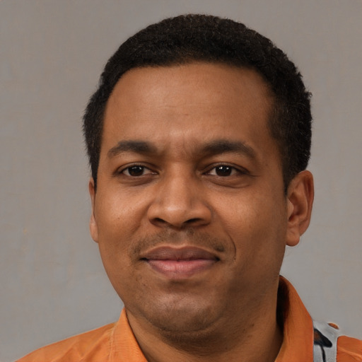 Joyful latino adult male with short  black hair and brown eyes