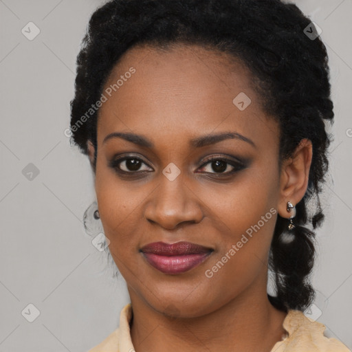 Joyful black young-adult female with long  black hair and brown eyes