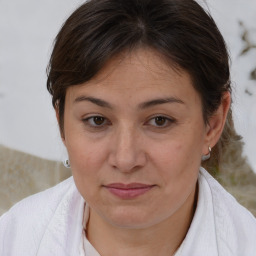 Joyful white adult female with medium  brown hair and brown eyes