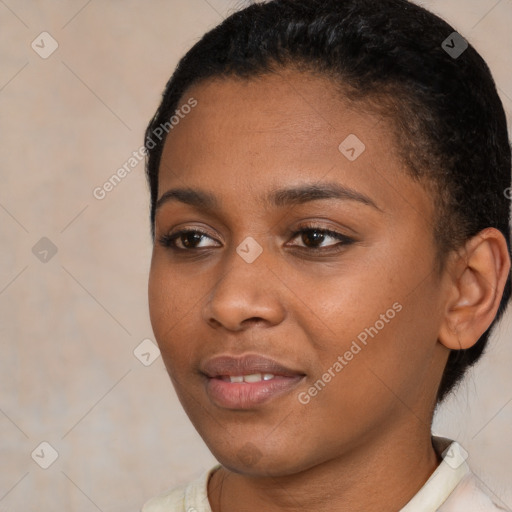 Joyful black young-adult female with short  black hair and brown eyes