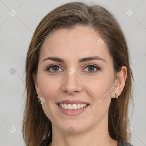 Joyful white young-adult female with medium  brown hair and grey eyes