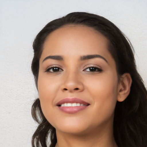 Joyful latino young-adult female with long  black hair and brown eyes