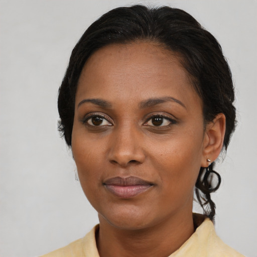 Joyful black adult female with medium  black hair and brown eyes