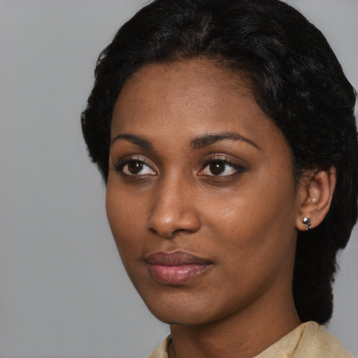 Neutral black young-adult female with medium  black hair and brown eyes