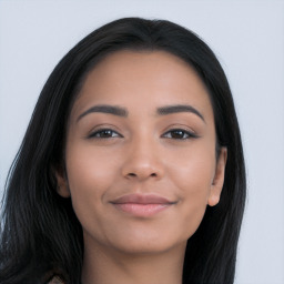 Joyful latino young-adult female with long  brown hair and brown eyes