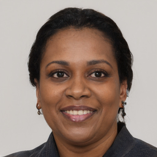 Joyful black adult female with short  black hair and brown eyes