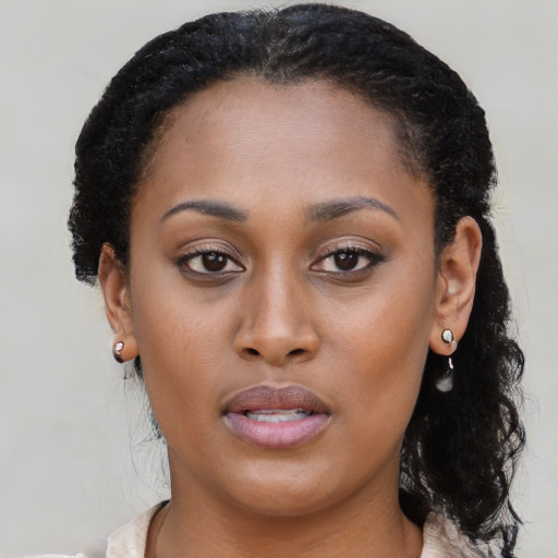 Joyful black young-adult female with medium  brown hair and brown eyes