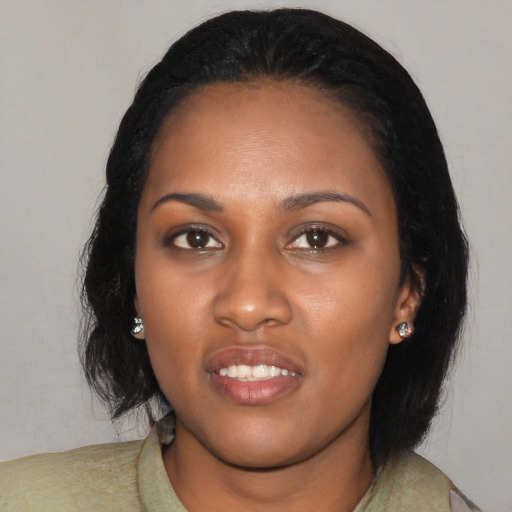 Joyful black young-adult female with medium  black hair and brown eyes