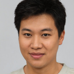 Joyful asian young-adult male with short  brown hair and brown eyes