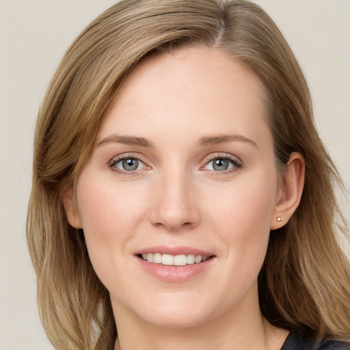 Joyful white young-adult female with long  brown hair and blue eyes