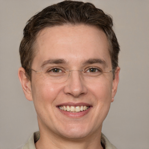 Joyful white adult male with short  brown hair and grey eyes