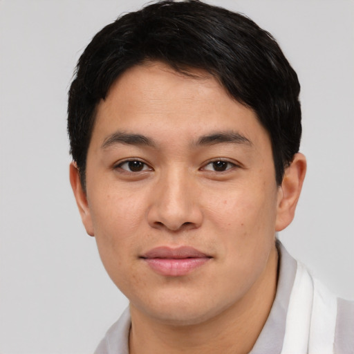 Joyful asian young-adult male with short  black hair and brown eyes