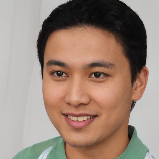 Joyful asian young-adult male with short  brown hair and brown eyes