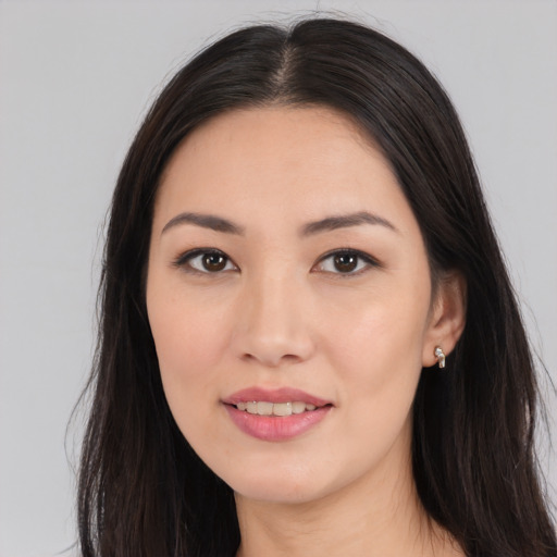 Joyful asian young-adult female with long  black hair and brown eyes