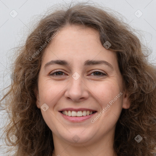 Joyful white adult female with long  brown hair and brown eyes