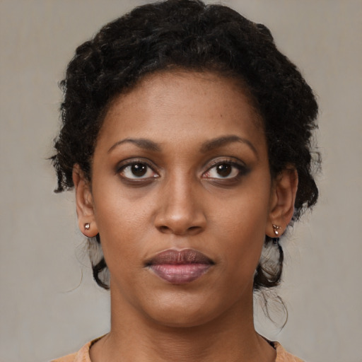 Neutral black young-adult female with medium  brown hair and brown eyes