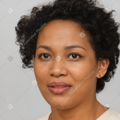 Joyful black adult female with short  brown hair and brown eyes