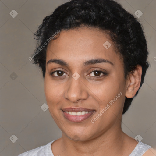 Joyful latino young-adult female with short  black hair and brown eyes