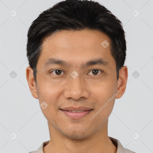 Joyful latino young-adult male with short  black hair and brown eyes