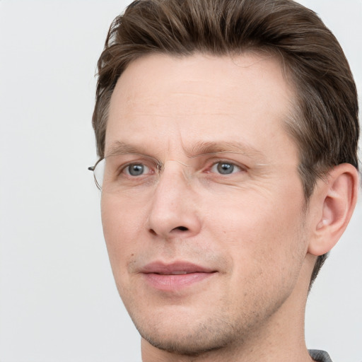 Joyful white adult male with short  brown hair and grey eyes