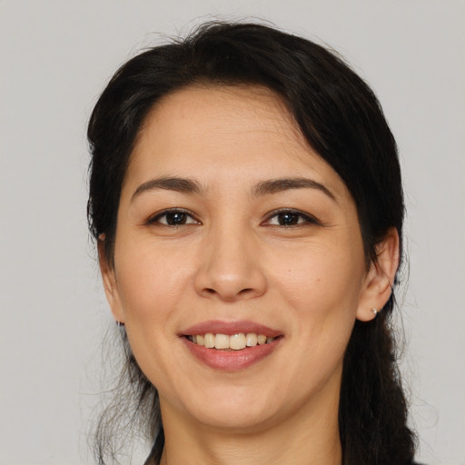 Joyful white young-adult female with medium  black hair and brown eyes