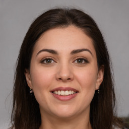 Joyful white young-adult female with long  brown hair and brown eyes