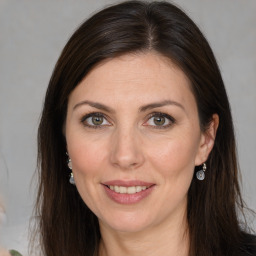 Joyful white adult female with long  brown hair and brown eyes