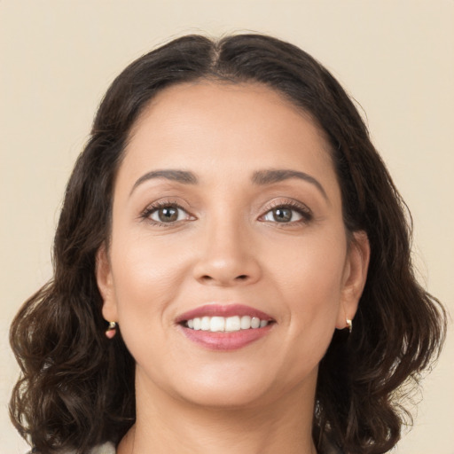 Joyful white young-adult female with long  brown hair and brown eyes