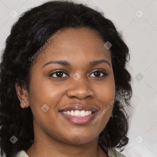 Joyful black young-adult female with long  brown hair and brown eyes