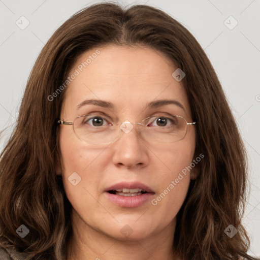 Joyful white adult female with long  brown hair and grey eyes