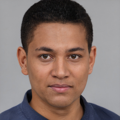 Joyful latino young-adult male with short  brown hair and brown eyes