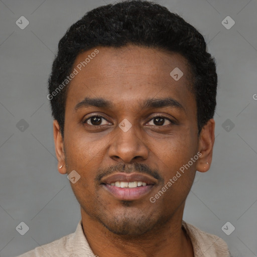 Joyful black young-adult male with short  black hair and brown eyes